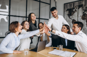 Team of professionals celebrating business management online course with a group high five